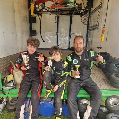 TLR drivers and team principal with trophies in the trailer